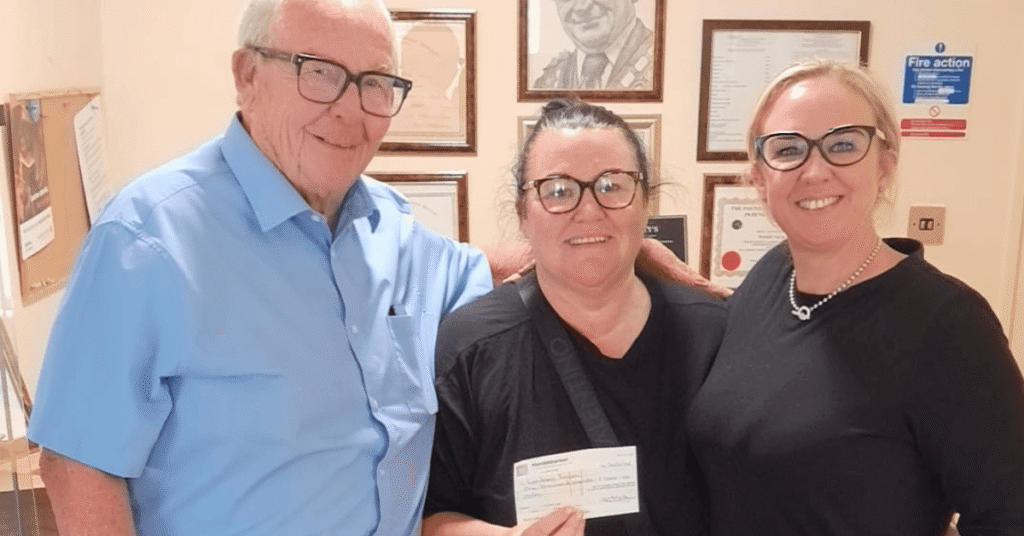 Bill Varty and Kristen Varty with Lexi's Mum accepting her donation
