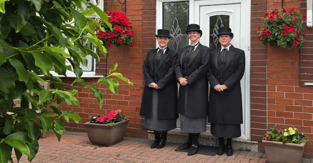 Bernadette, Kristen and Diane stood smiling in their funeral service uniforms