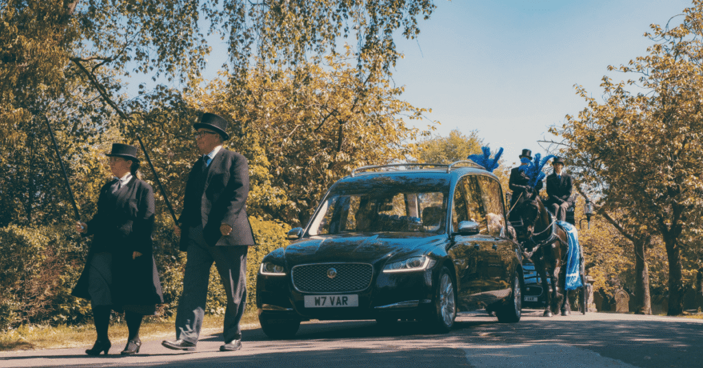 Bill Varty Leading a hearse and horses