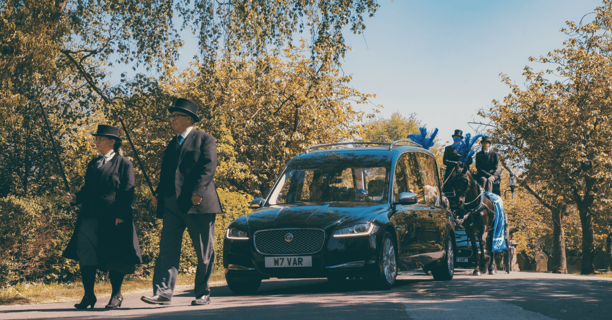 Bill Varty Leading a hearse and horses