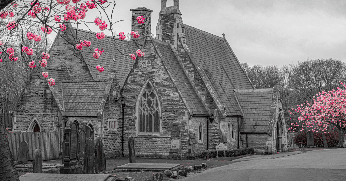 Black and white photo of Wigan Crematorium with pink cherry blossom